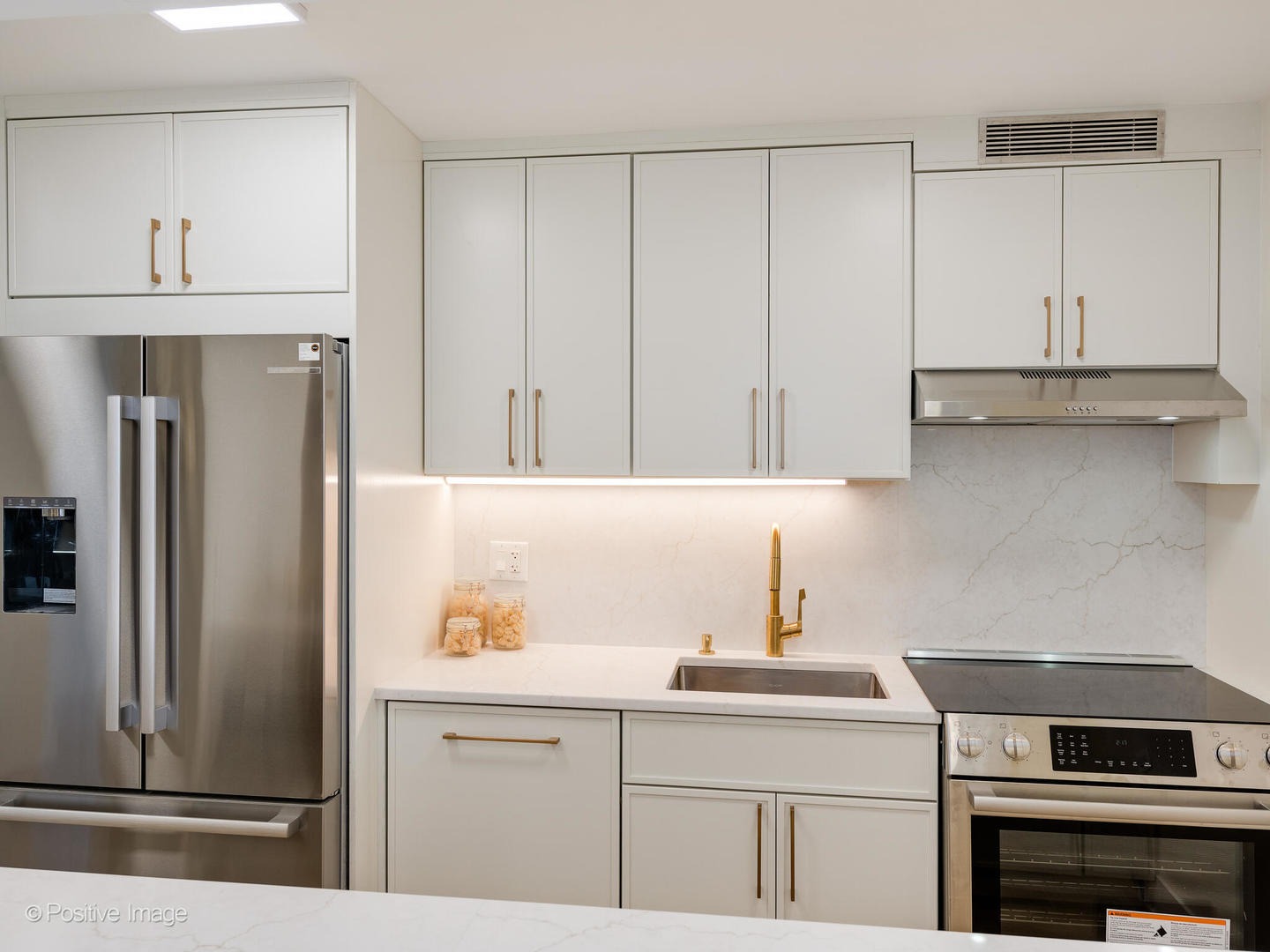 1310 North Ritchie Court, Unit 27B Chicago, IL 60610 - Photo 4 of 29 a kitchen with stainless steel appliances a refrigerator and cabinets
