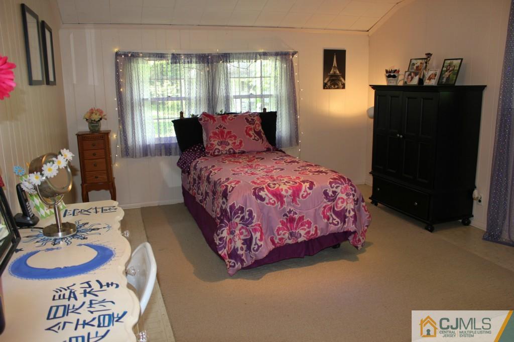 29 Huntington Road Edison, NJ 08820 - Photo 14 of 20 a bedroom with a bed and dresser
