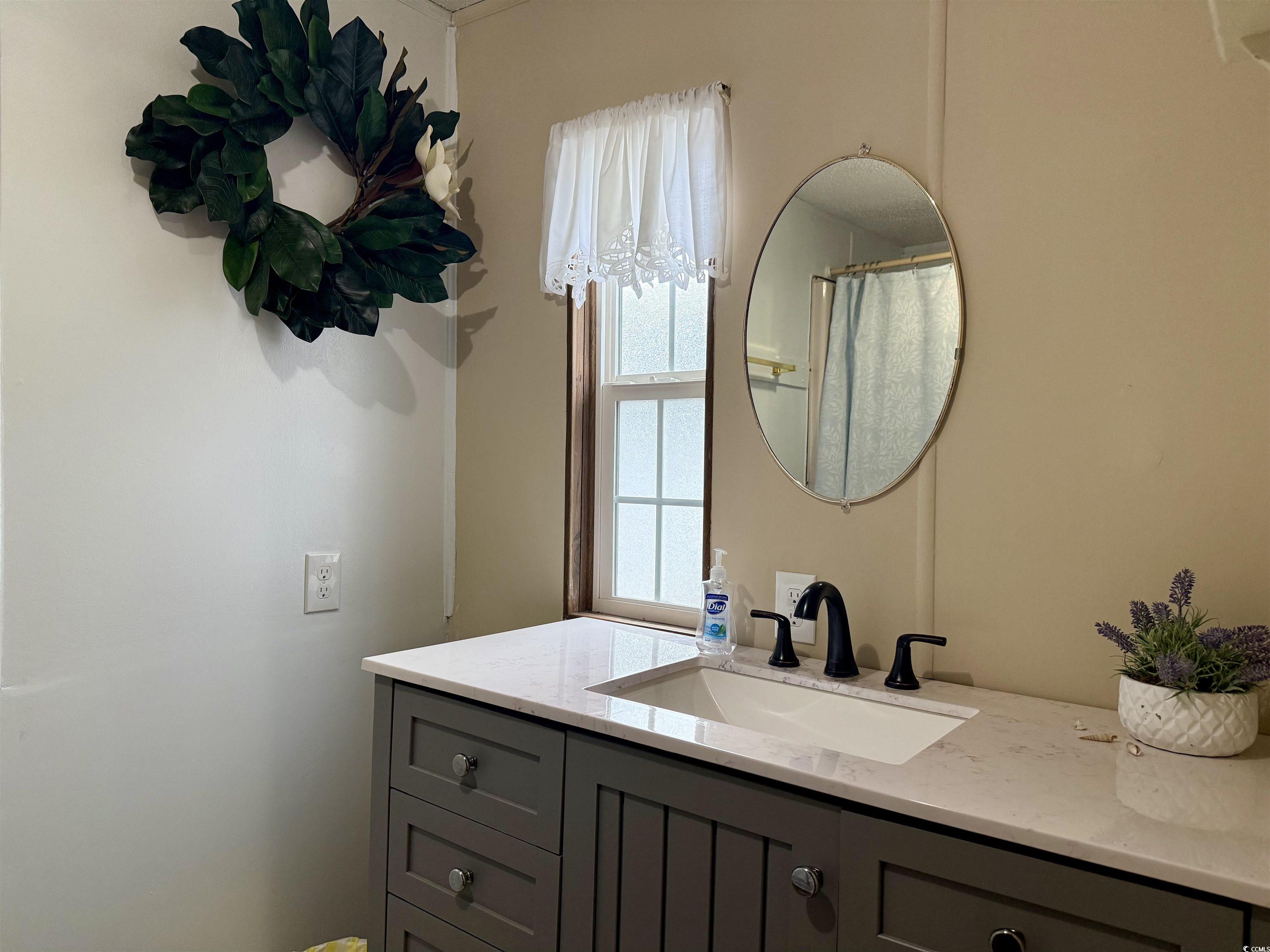 1801 E Lake Surfside Beach, SC 29575 - Photo 13 of 32 Full bath with vanity and a shower with shower curtain