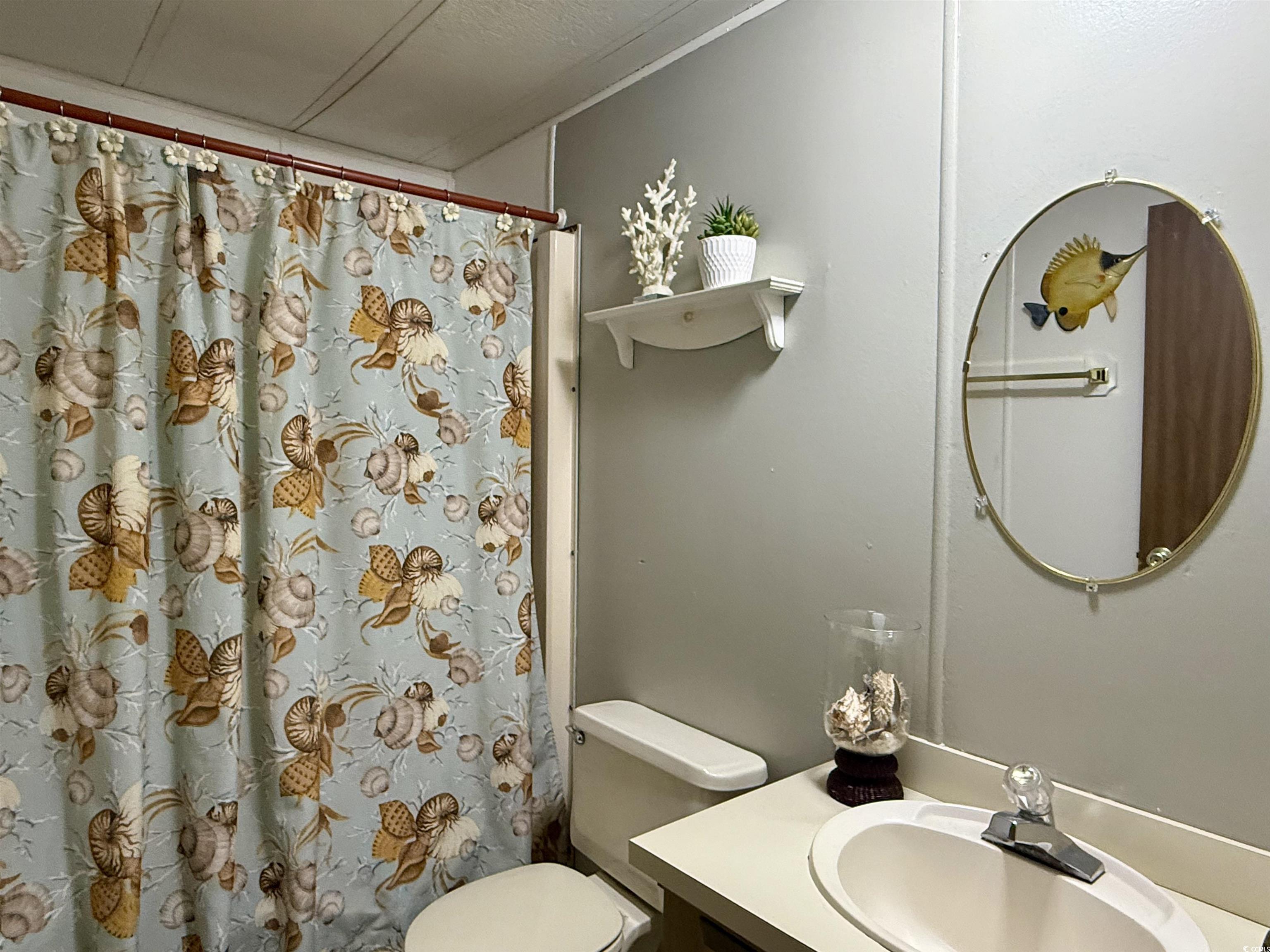 1801 E Lake Surfside Beach, SC 29575 - Photo 17 of 32 Bathroom with vanity and curtained shower