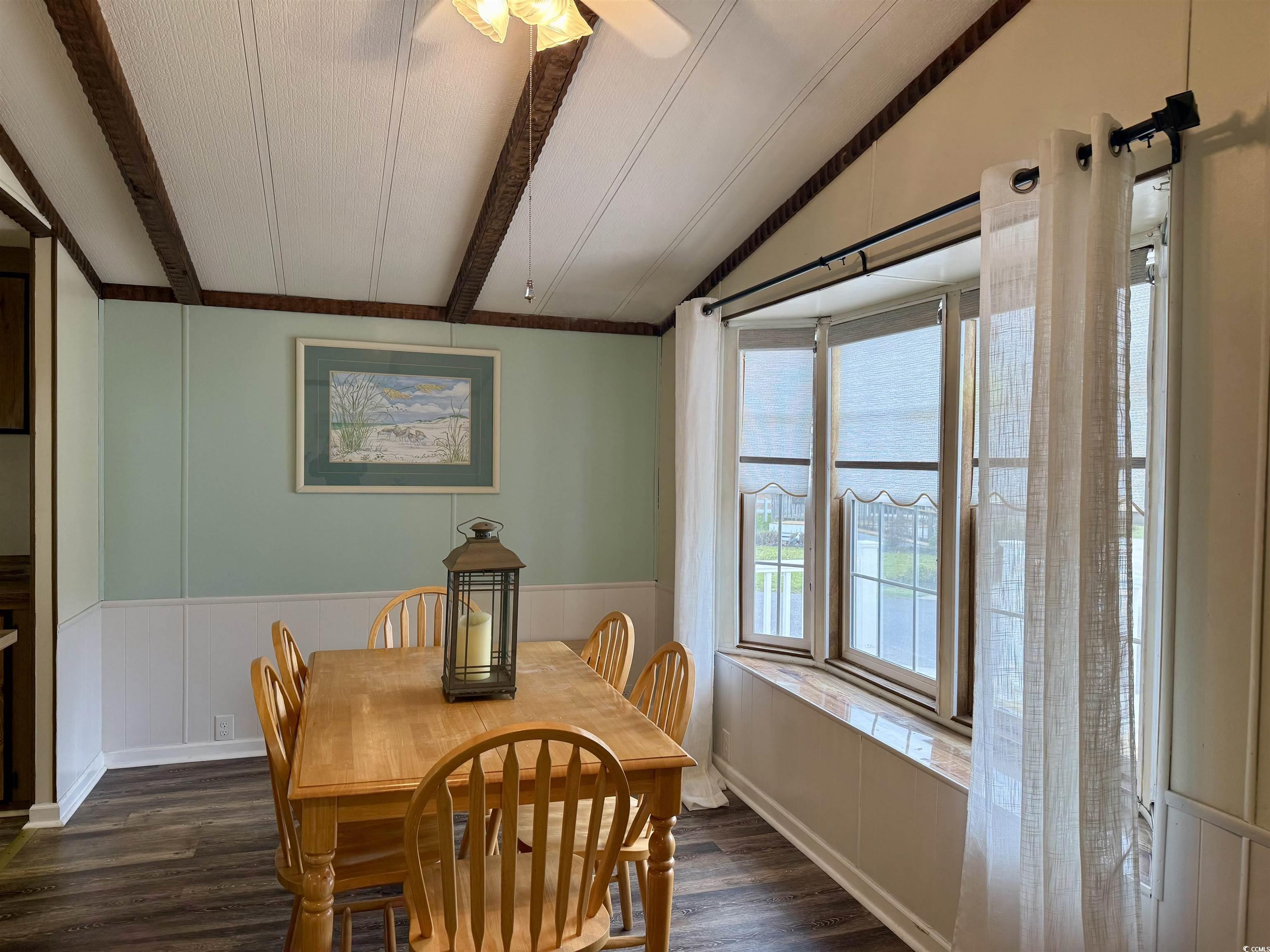 1801 E Lake Surfside Beach, SC 29575 - Photo 8 of 32 Dining space with a wainscoted wall, dark wood-style floors, and ceiling fan