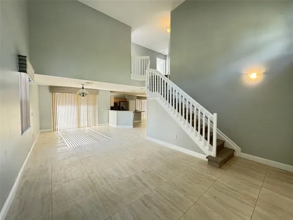 a view of staircase with white walls and a window