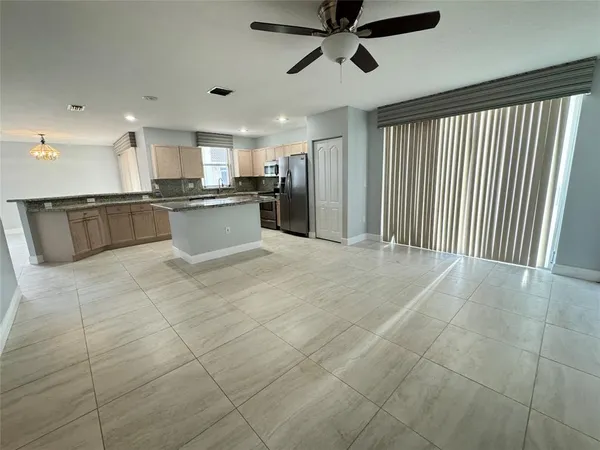 a large kitchen with a large counter top and stainless steel appliances