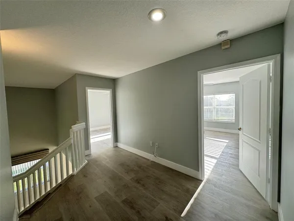a view of hallway with wooden floor