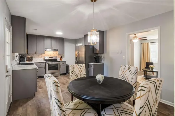 a kitchen with refrigerator cabinets dining table and chairs
