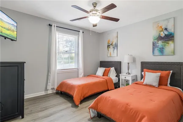 a bedroom with two beds and a window