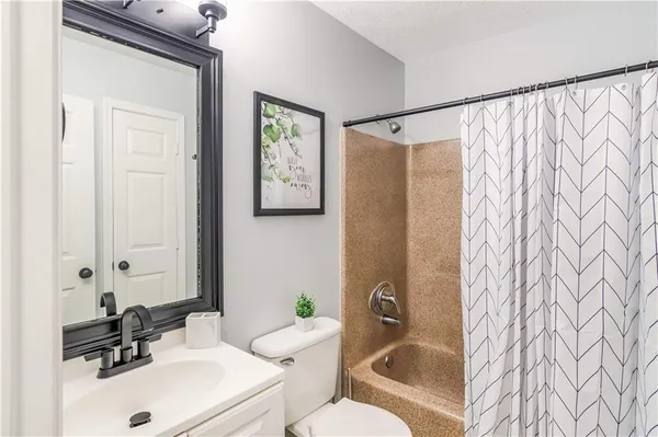 a bathroom with a sink mirror vanity and toilet