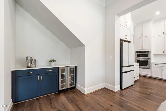 a view of a dining room with furniture a chandelier and wooden floor