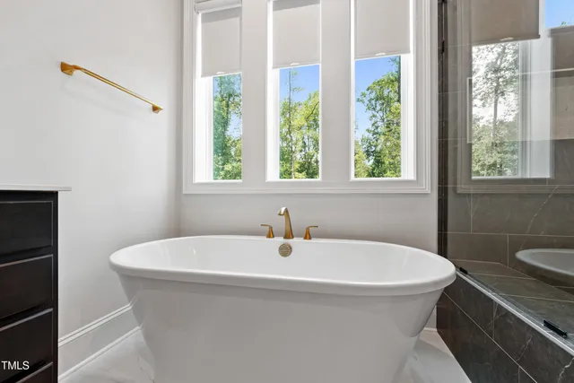 a living room with fireplace furniture and a large window