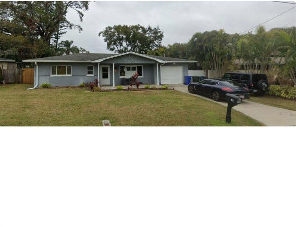 a view of house with backyard space and balcony