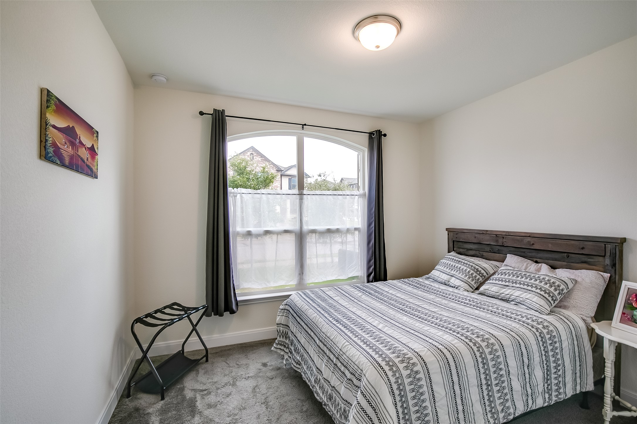 7616 Groundhog Way Austin, TX 78744 - Photo 23 of 34 a bedroom with a bed and glass door