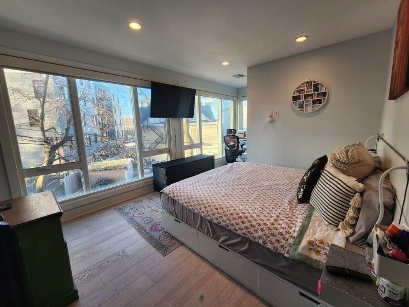 533 Cambridge Street, Unit 105 Boston, MA 02134 - Photo 11 of 32 a bedroom with a large bed and a large window