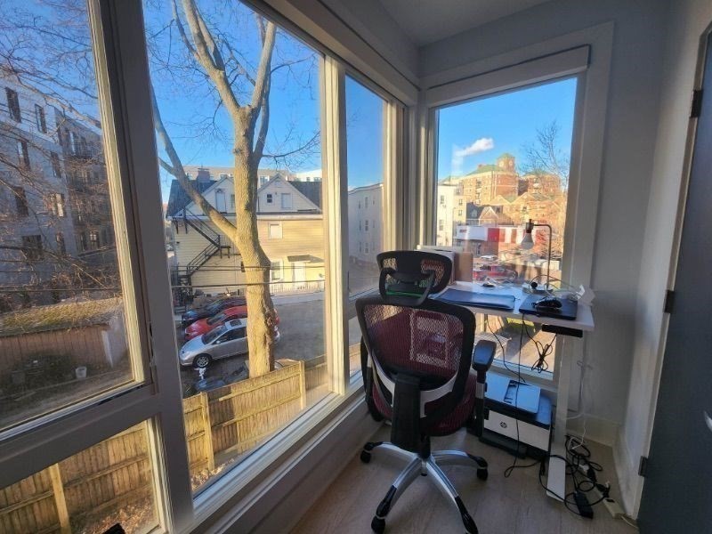 533 Cambridge Street, Unit 105 Boston, MA 02134 - Photo 12 of 32 a living room with furniture and a window