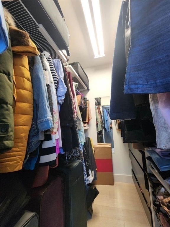 533 Cambridge Street, Unit 105 Boston, MA 02134 - Photo 13 of 32 a view of walk in closet with clothes and shoes