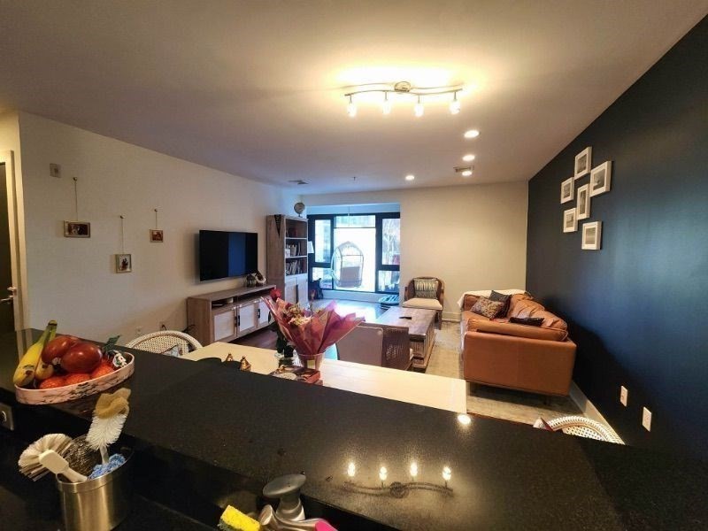 533 Cambridge Street, Unit 105 Boston, MA 02134 - Photo 20 of 32 a living room with furniture and a flat screen tv