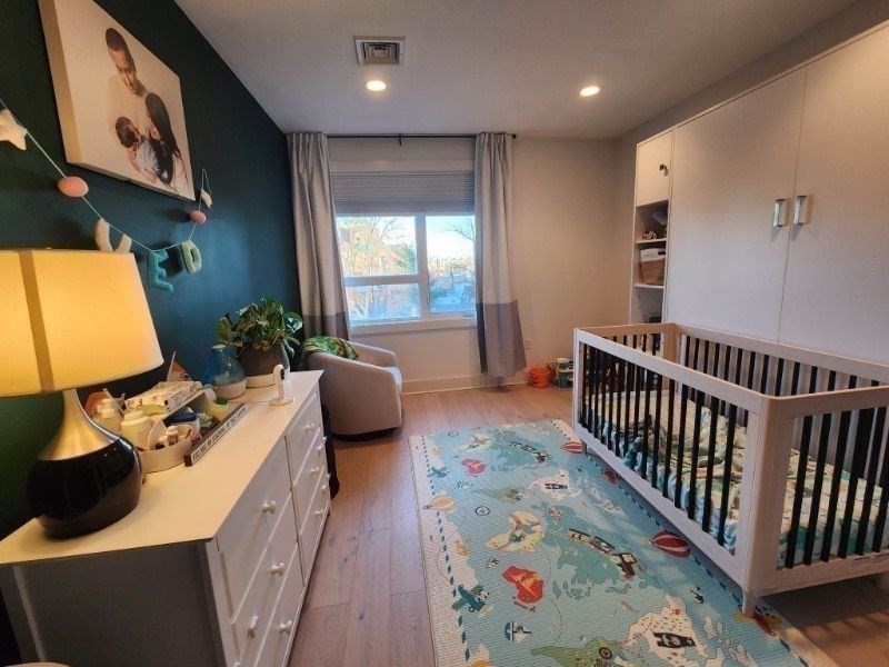 533 Cambridge Street, Unit 105 Boston, MA 02134 - Photo 5 of 32 a bedroom with furniture and a window