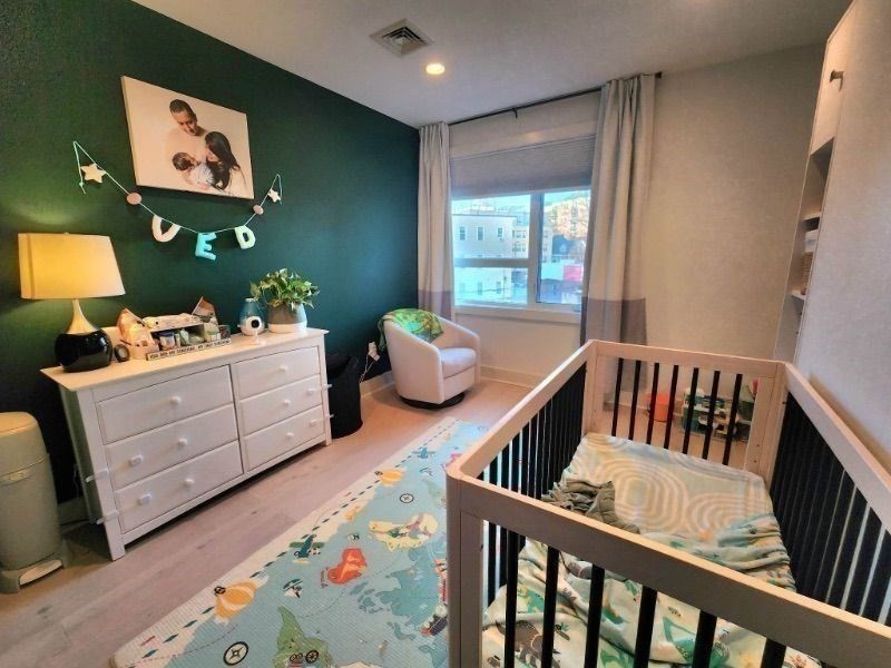 533 Cambridge Street, Unit 105 Boston, MA 02134 - Photo 7 of 32 a bedroom with furniture and a window