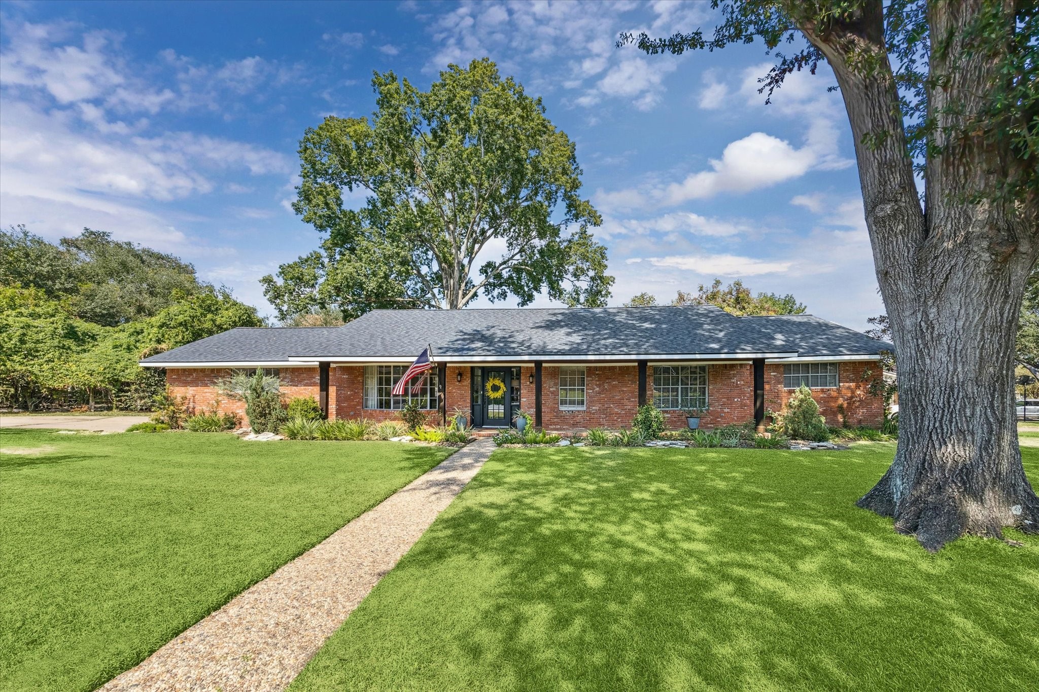 a front view of house with yard and green space
