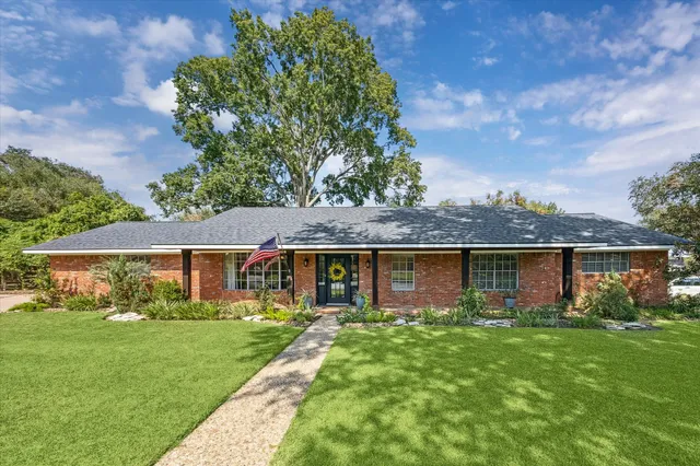 a view of a backyard with a small cabin and wooden fence