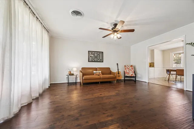 a living room with furniture window and wooden floor