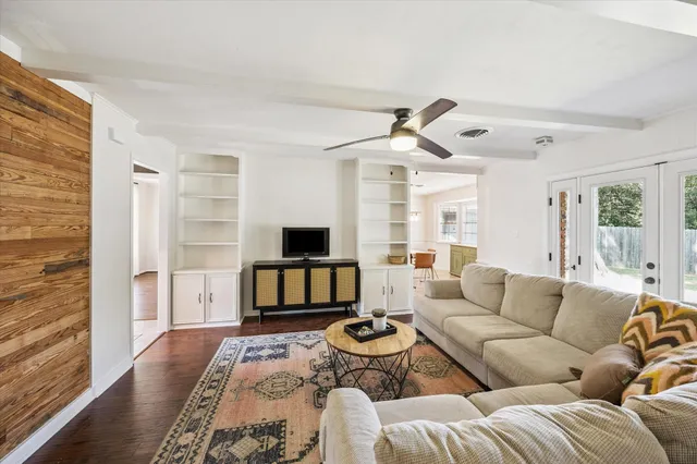 a living room with furniture ceiling fan and a rug
