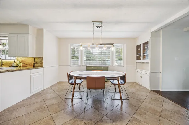 a view of a dining room with furniture and a chandelier