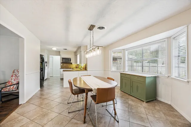 a large kitchen with stainless steel appliances granite countertop a sink and cabinets