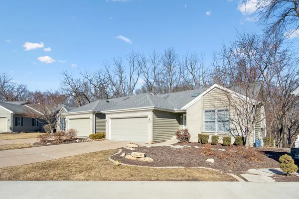 a front view of a house with a yard covered in snow