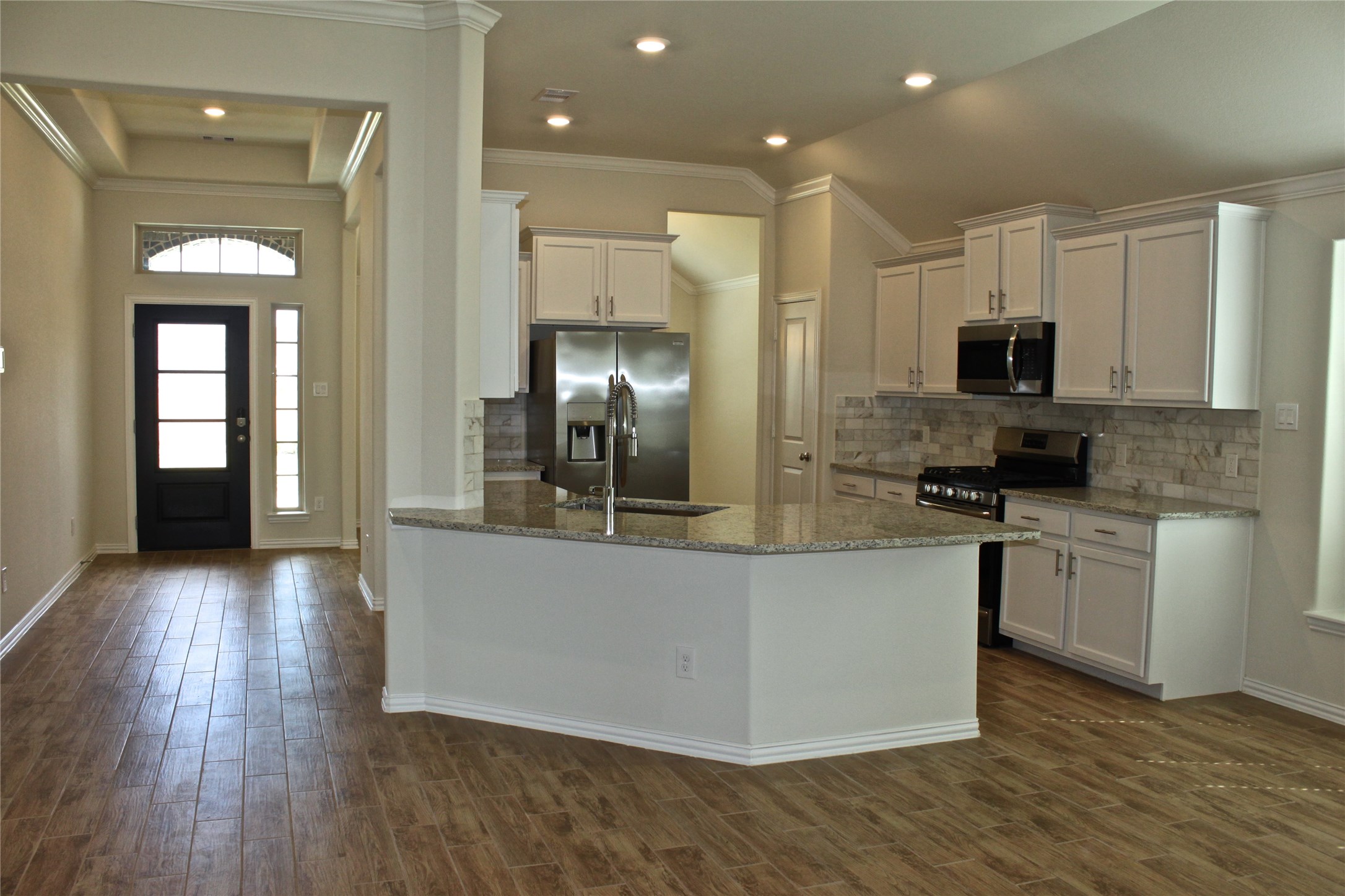4408 Mimic Drive Spring, TX 77386 - Photo 2 of 27 a kitchen with stainless steel appliances granite countertop a stove top oven a sink and a granite counter top