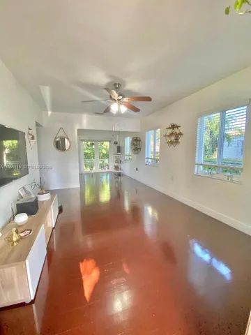 a living room with fireplace furniture and a large window