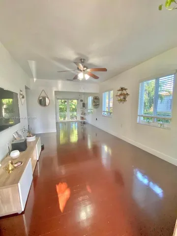 a view of a livingroom with furniture and mirror
