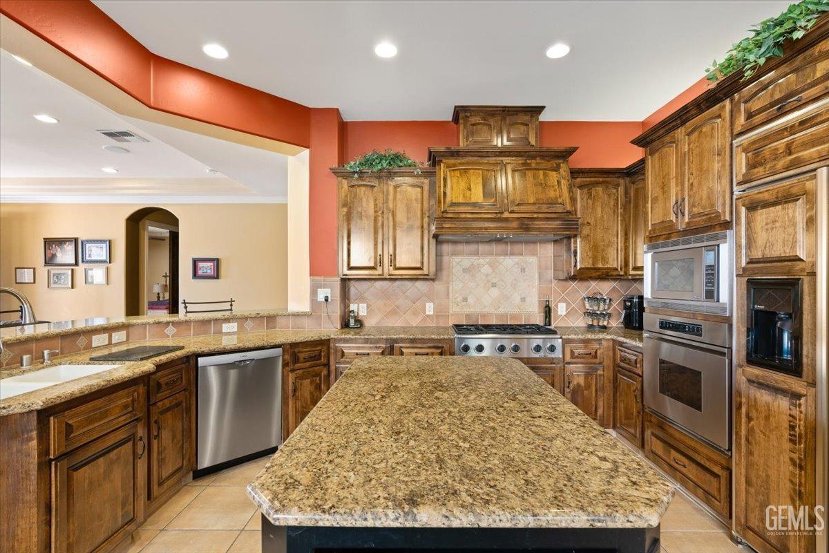 Undisclosed Address Bakersfield, CA 93311 - Photo 11 of 41 a large kitchen with stainless steel appliances granite countertop a sink stove and refrigerator