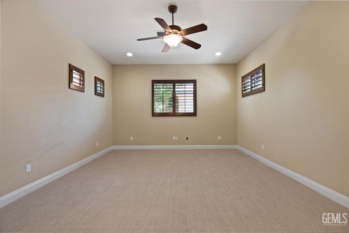 Undisclosed Address Bakersfield, CA 93311 - Photo 14 of 41 an empty room with a window and a ceiling fan