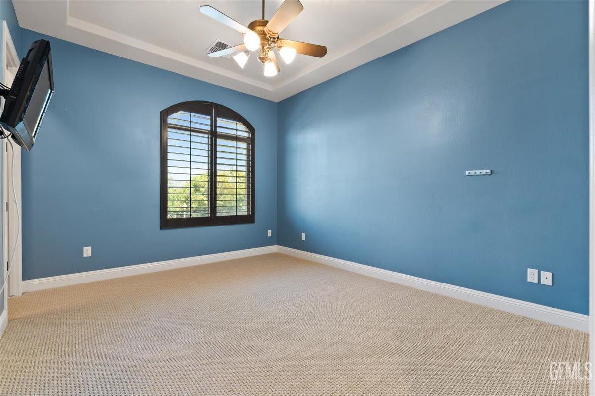 Undisclosed Address Bakersfield, CA 93311 - Photo 20 of 41 an empty room with windows and chandelier fan