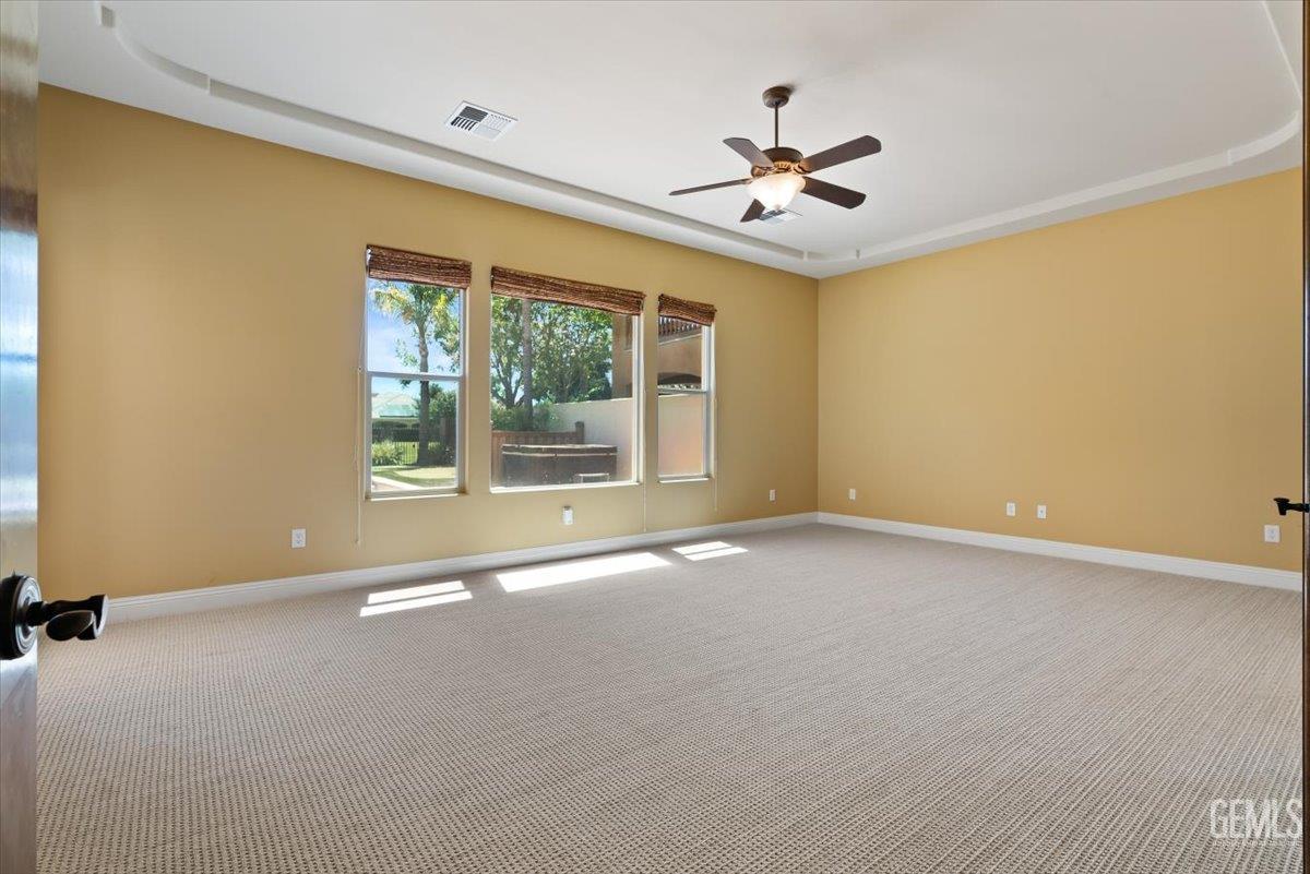 Undisclosed Address Bakersfield, CA 93311 - Photo 22 of 41 an empty room with windows and ceiling fan