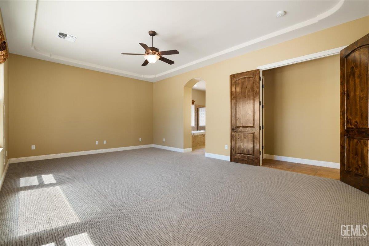 Undisclosed Address Bakersfield, CA 93311 - Photo 24 of 41 a view of an empty room with a ceiling fan