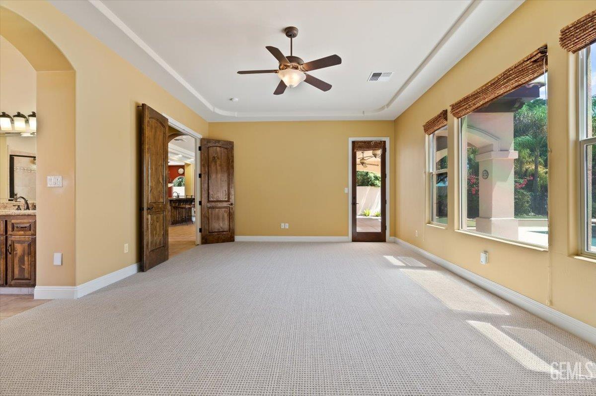 Undisclosed Address Bakersfield, CA 93311 - Photo 25 of 41 an empty room with chandelier fan and windows