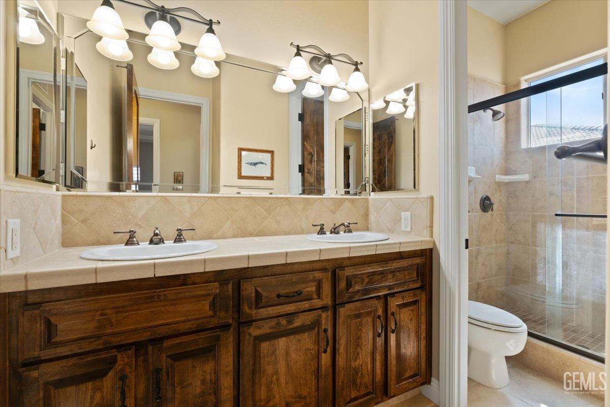 Undisclosed Address Bakersfield, CA 93311 - Photo 29 of 41 a bathroom with a granite countertop sink mirror and toilet