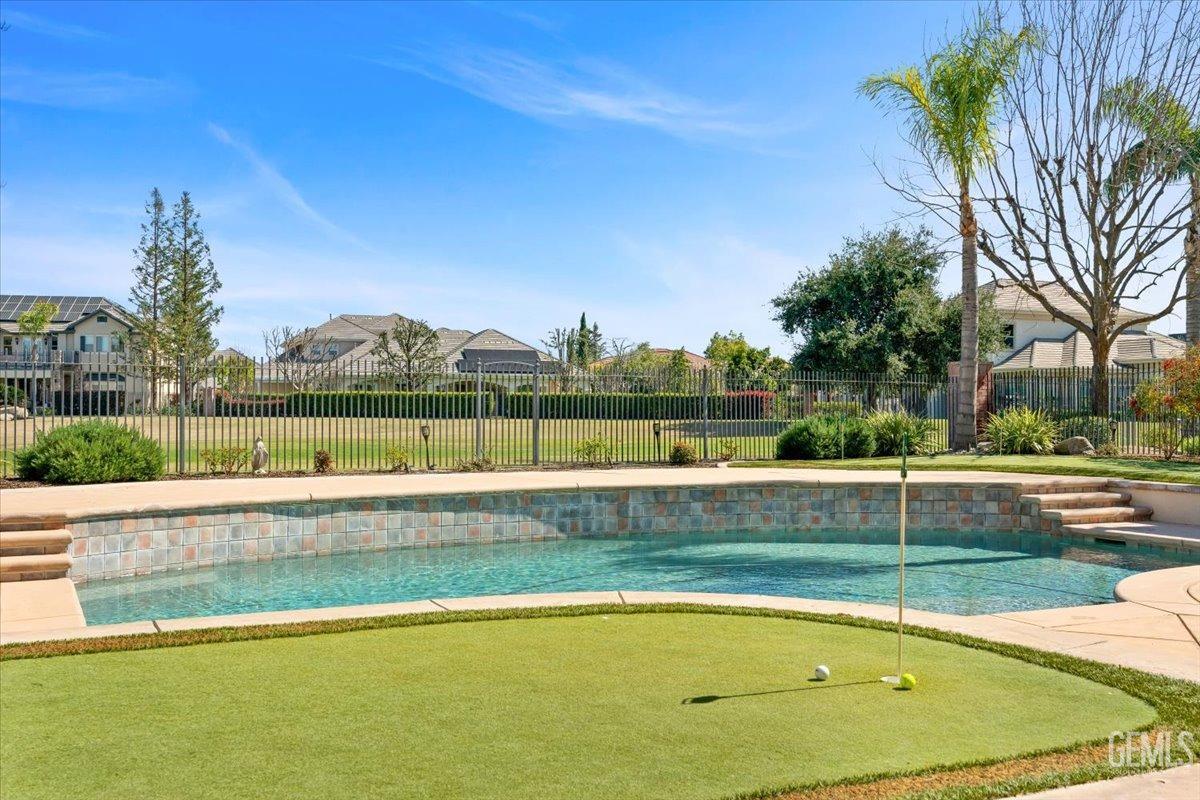 Undisclosed Address Bakersfield, CA 93311 - Photo 32 of 41 a view of a swimming pool and a yard