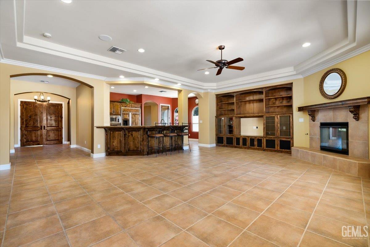 Undisclosed Address Bakersfield, CA 93311 - Photo 6 of 41 a view of an empty room with a fireplace and a window