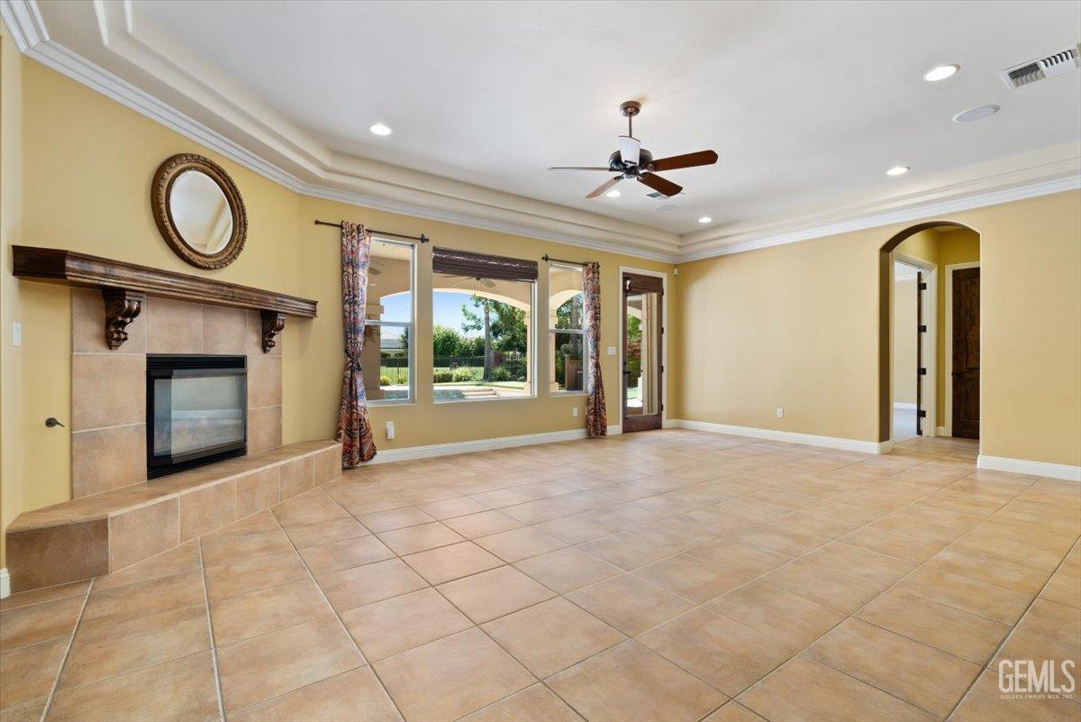 Undisclosed Address Bakersfield, CA 93311 - Photo 8 of 41 a view of an empty room with a fireplace and a window
