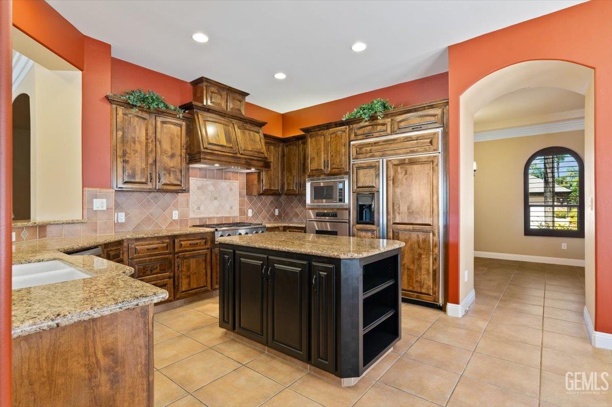 Undisclosed Address Bakersfield, CA 93311 - Photo 10 of 41 a kitchen with a stove a sink and a refrigerator