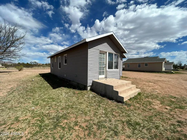 a backyard of a house with wooden fence
