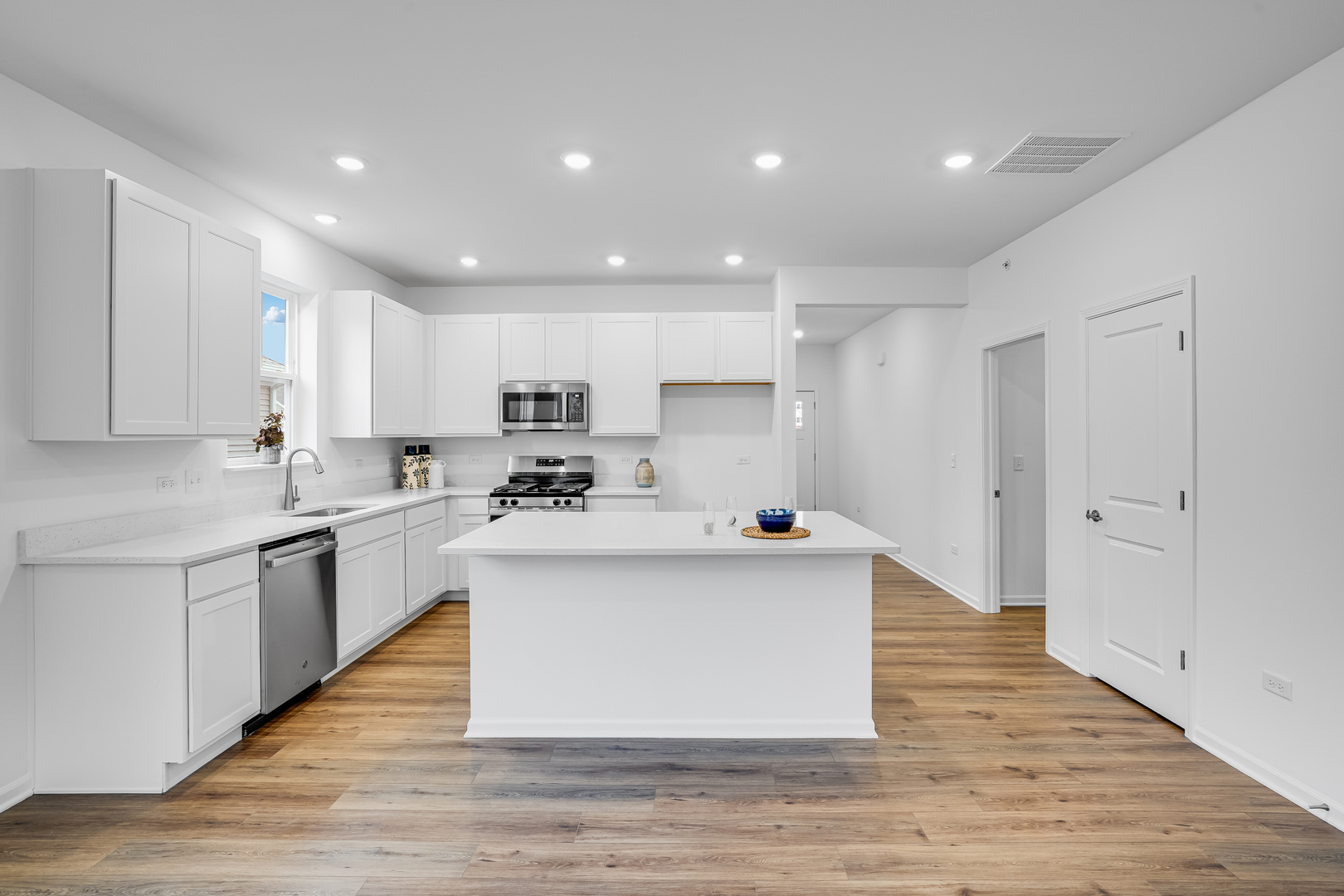 12246 Barcroft Circle Huntley, IL 60142 - Photo 3 of 36 a large kitchen with stainless steel appliances a large counter top a stove and a sink
