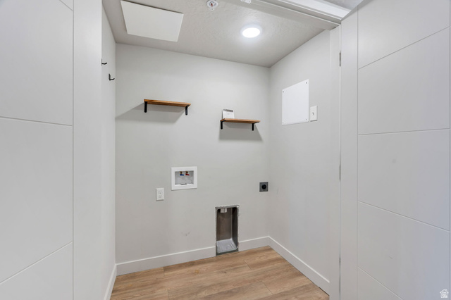 572 South 100 West, Unit E210 Springville, UT 84663 - Photo 22 of 35 Dedicated laundry area with wood-finish flooring, two wall-mounted shelves, recessed lighting, and modern white trim