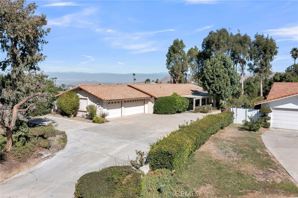 6176 Oswego Drive Riverside, CA 92506 - Photo 1 of 1 an aerial view of a house with a yard and mountain view in back