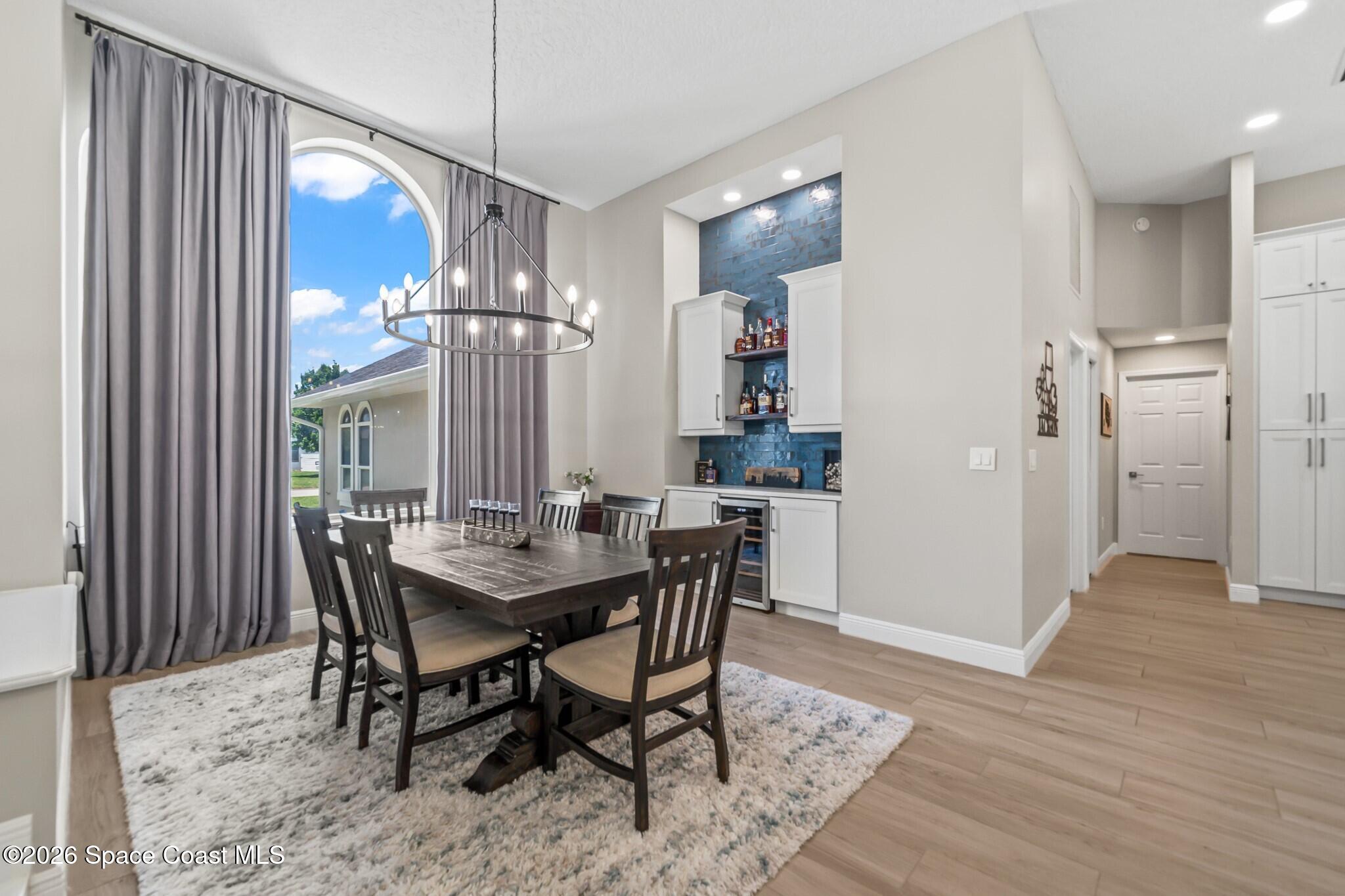 697 Spring Lake Drive Melbourne, FL 32940 - Photo 9 of 45 a view of a dining room with furniture and wooden floor