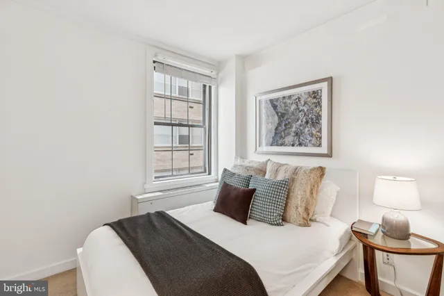 a bedroom with a bed and window