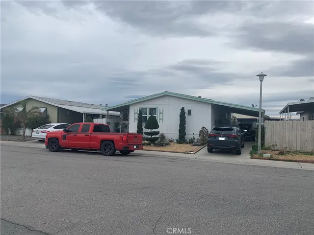 a view of car parked in a parking lot at street side