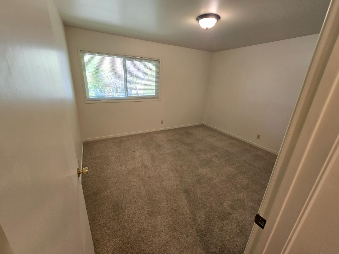 801 Fairfield Road, Unit 6 Burlingame, CA 94010 - Photo 9 of 16 an empty room with windows